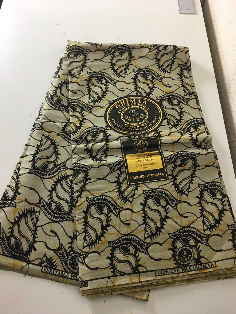 African fabric sold per yard. Beige and black Colour