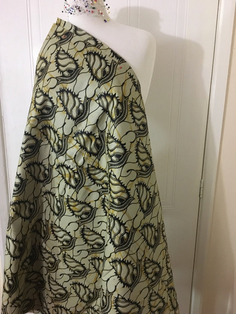 African fabric sold per yard. Beige and black Colour