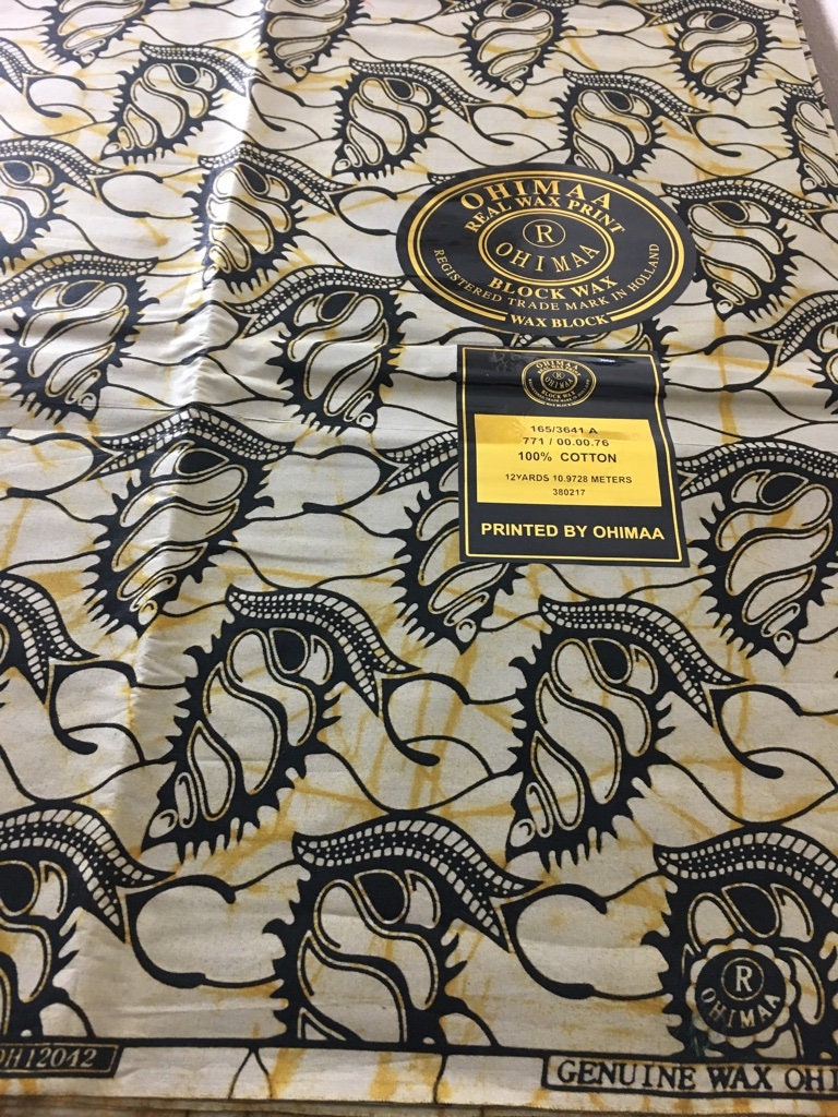 African fabric sold per yard.  Beige and black Colour